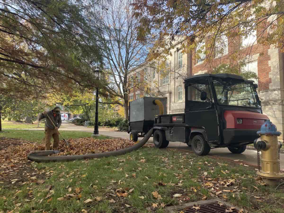 Professional crew performing complete fall cleanup on Columbia property with leaves and equipment