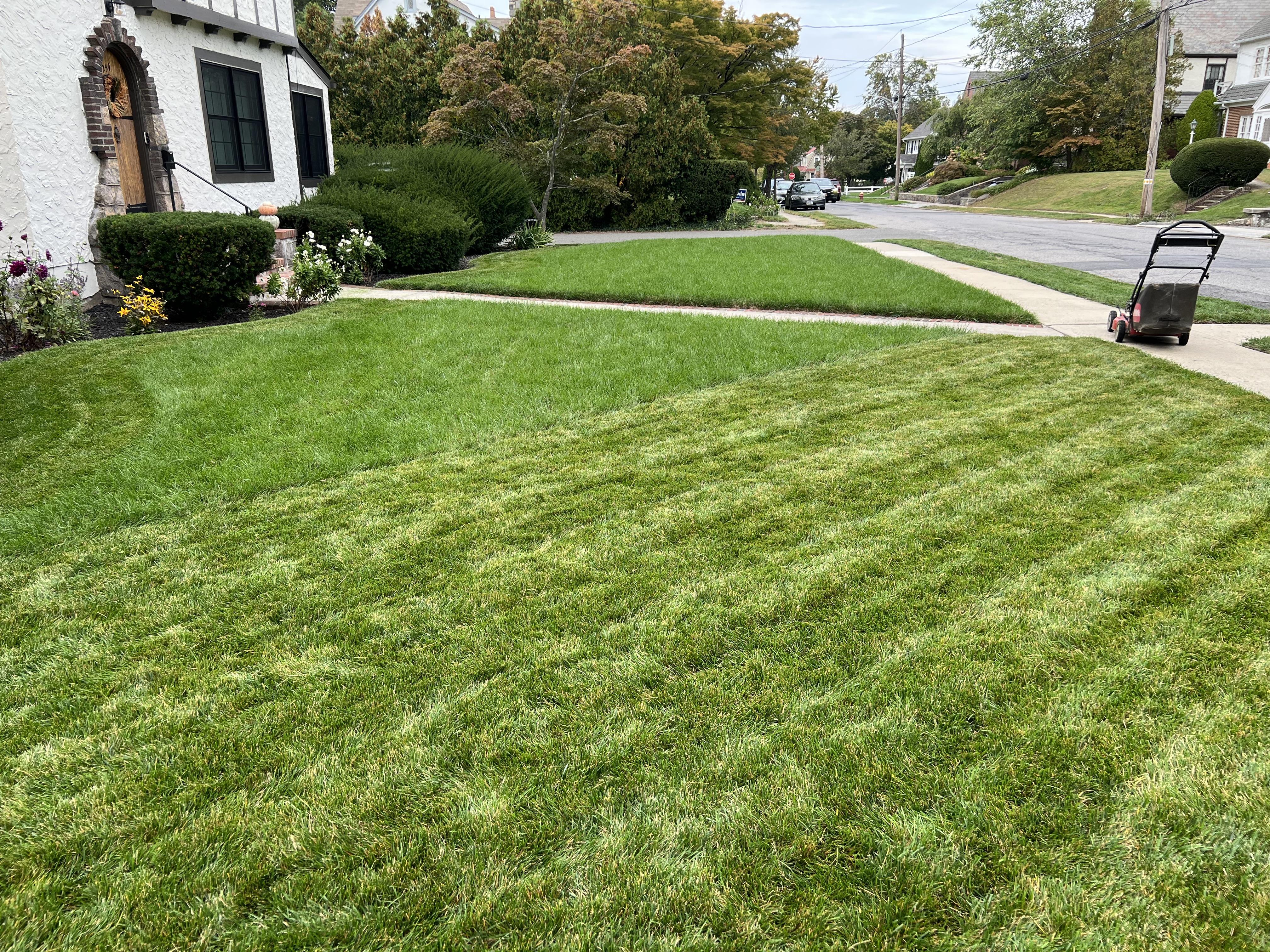 Side-by-side calendar comparison showing weekly mowing schedule with 28 marks versus bi-weekly schedule with 14 marks across season